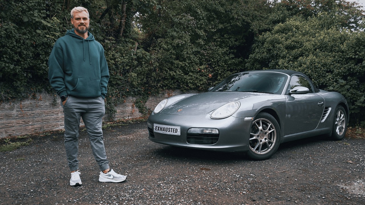 Josh beside a Porsche Boxster in the featured Exhausted Wallet video
