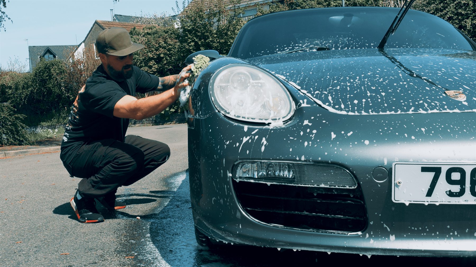Josh cleaning his Porsche Boxster